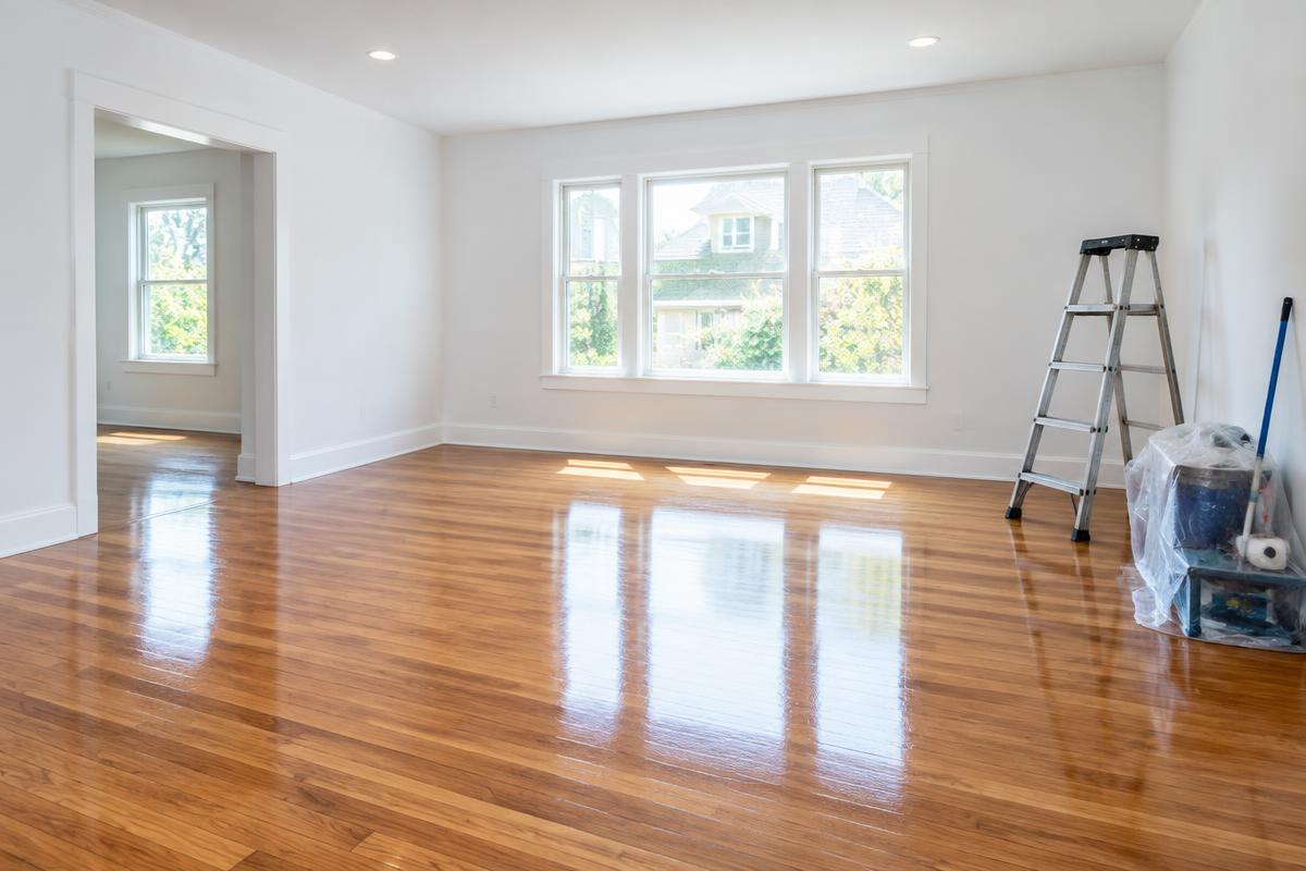Freshly renovated room with shining wood floors after post-construction cleaning